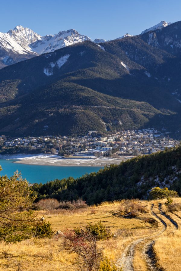 Elevated view over Savines-le-Lac Village and Serre Poncon lake in winter. Hautes-Alpes, Southern Alps, France